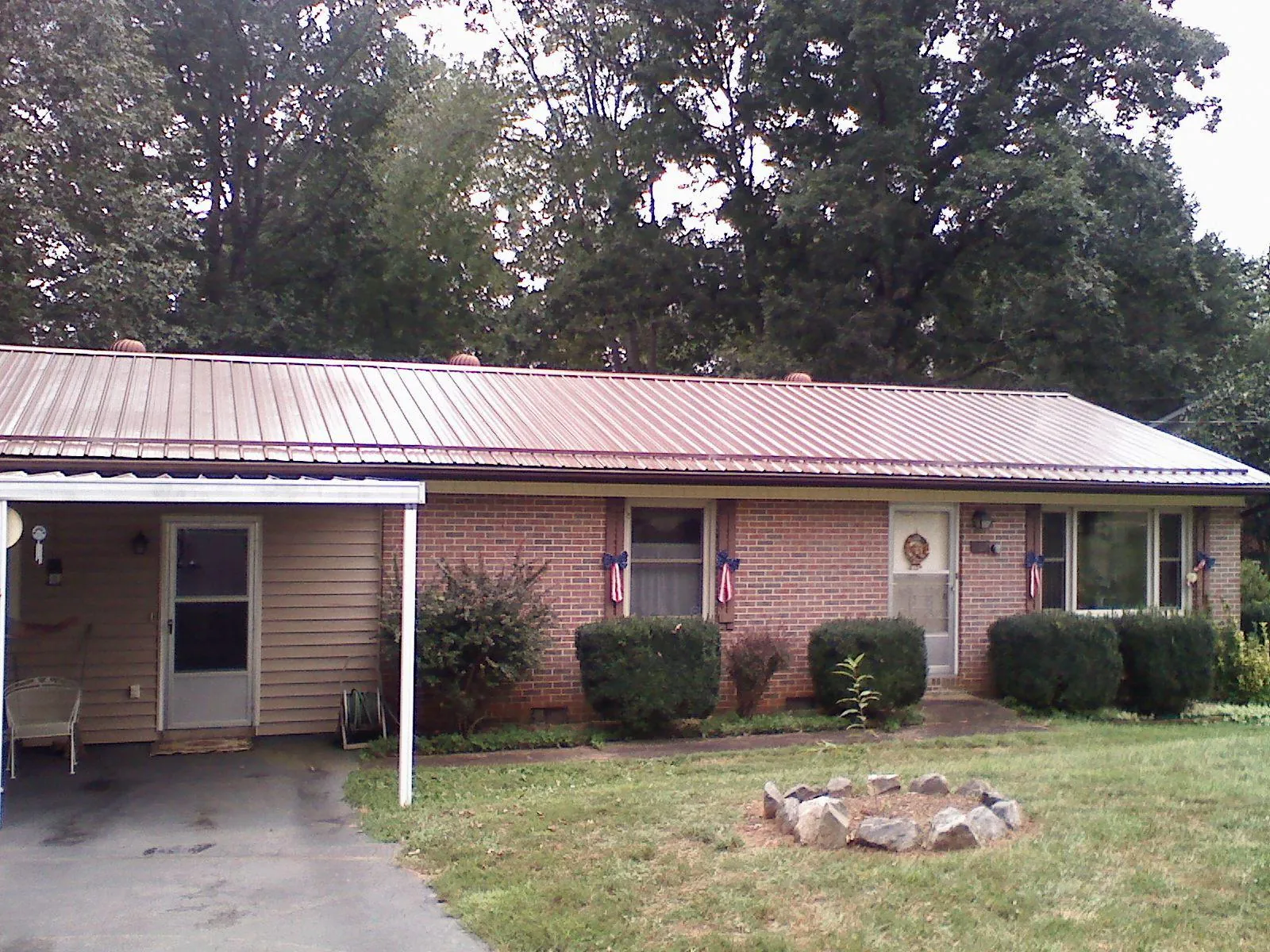 Bronze metal roof and carport on a brick ranch home in Carlstadt