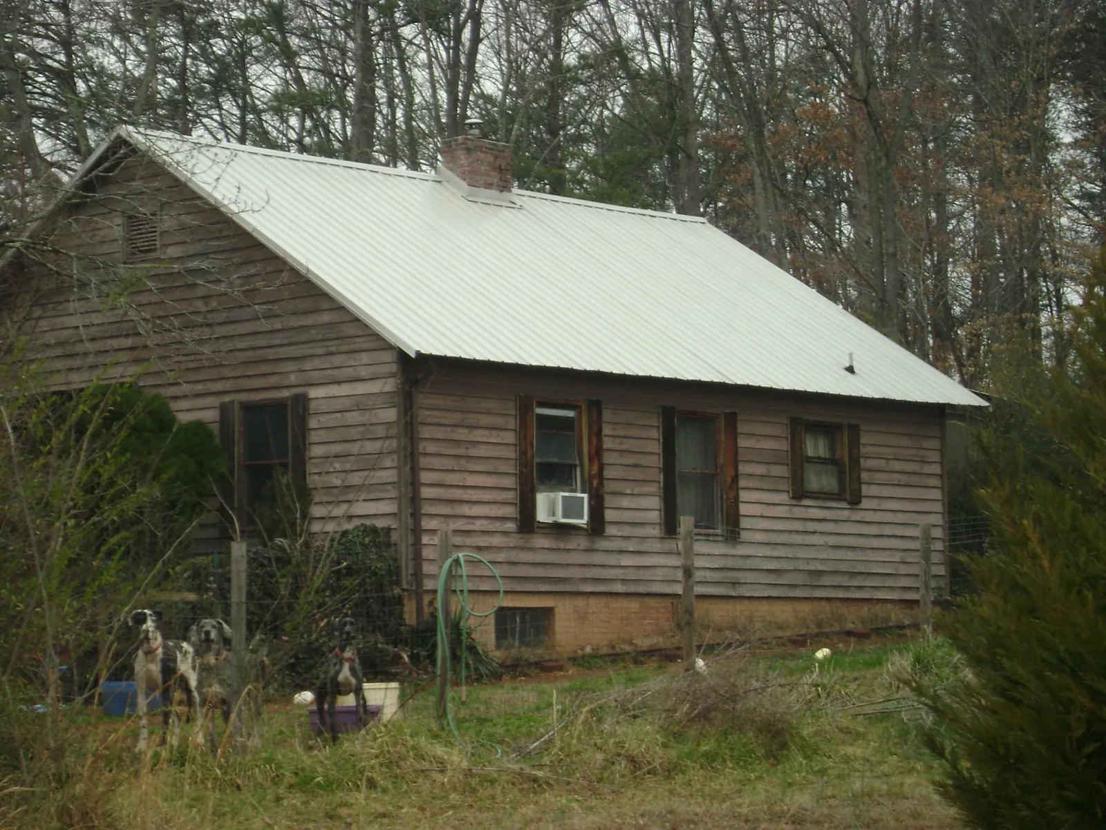 White metal roof on an old wood sided farmhouse, from a Metal Roof Installation job in Carlstadt